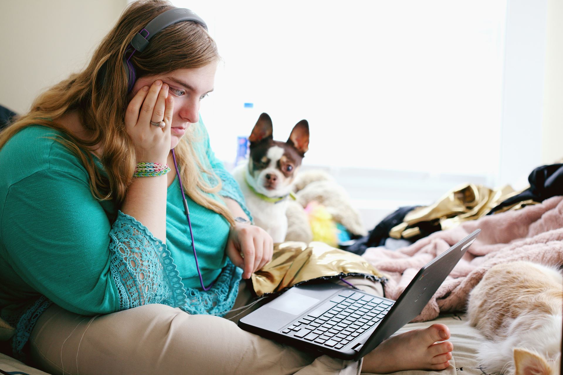 Woman with headphones on using a laptop